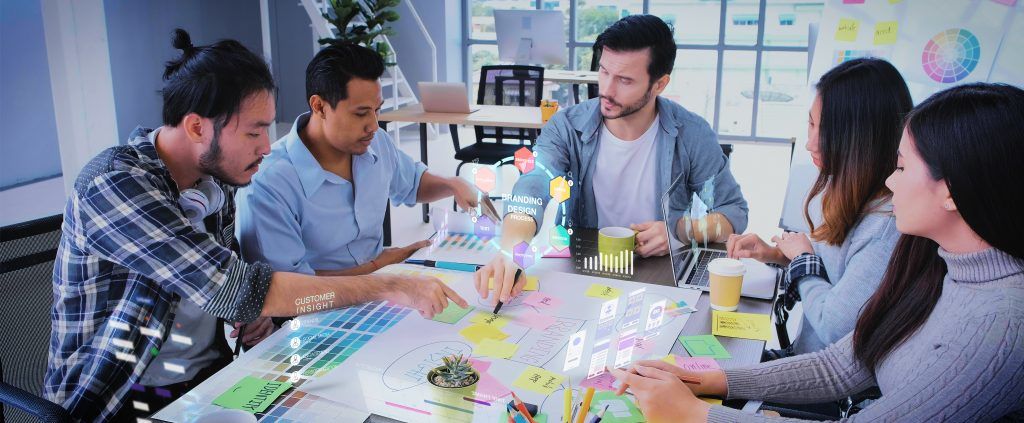 Close up ux developer and ui designer use augmented reality app brainstorming about mobile interface wireframe design on desk at modern office.Creative digital development agency