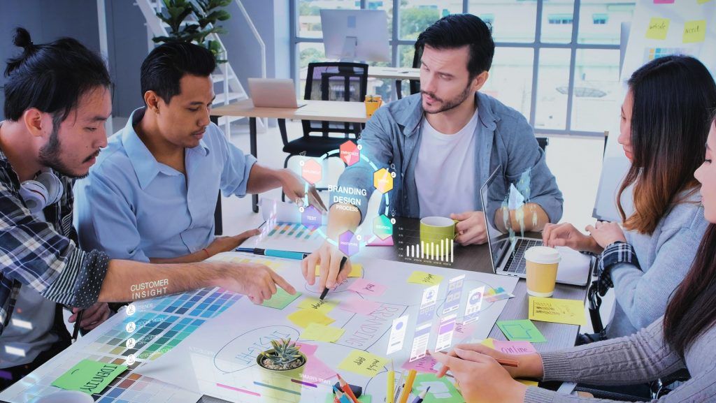Close up ux developer and ui designer use augmented reality app brainstorming about mobile interface wireframe design on desk at modern office.Creative digital development agency