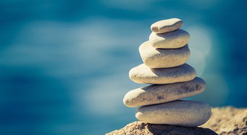 Balance spa wellness concept Balance and wellness retro spa concept, inspiration, zen-like and well being tranquil composition. Close-up of white pebbles stack over blue sea